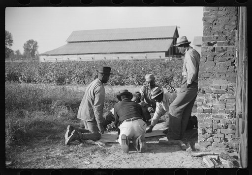 Untitled photo, possibly related to: Negroes shooting craps behind tenant house, disposing of their cotton money on Saturday afternoon, Marcella Plantation, Mileston, Mississippi Delta, Mississippi