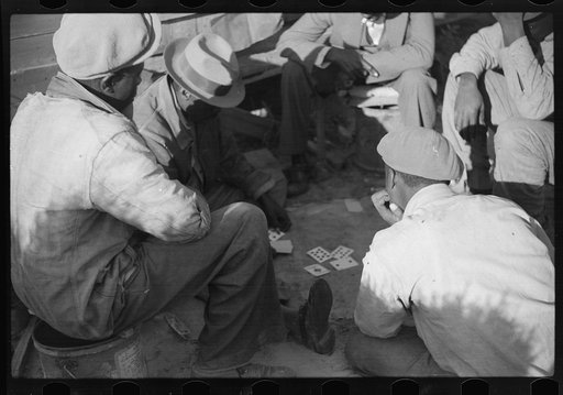 Negroes shooting craps behind tenant house, disposing of their cotton money on Saturday afternoon, Marcella Plantation, Mileston, Mississippi Delta, Mississippi