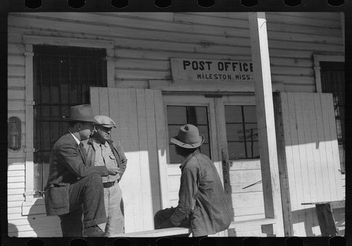 Untitled photo, possibly related to: Mr. Jones, one of the owners of Marcella Plantation, with manager of Goodhope Plantation talking to one of Negro tenants on porch of Plantation store and post office, Mileston, Mississippi Delta, Mississippi