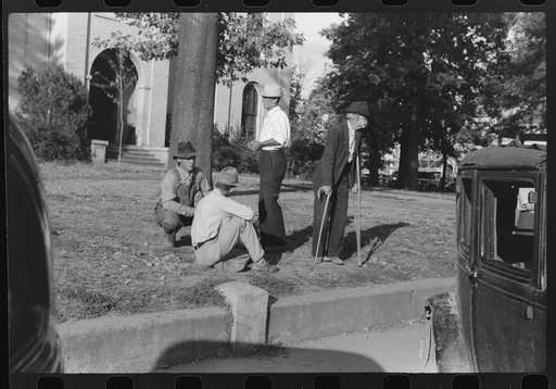 Men visiting together in front of courthouse on Saturday afternoon, Lexington, Mississippi Delta, Mississippi
