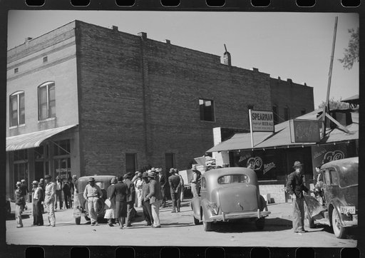 Untitled photo, possibly related to: Some of the Negroes watching itinerant salesman selling goods from his truck in center of town. On Saturday afternoon. Belzoni, Mississippi Delta, Mississippi