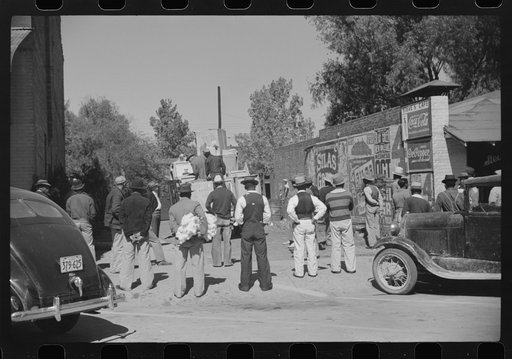 Untitled photo, possibly related to: Some of the Negroes watching itinerant salesman selling goods from his truck in center of town. On Saturday afternoon. Belzoni, Mississippi Delta, Mississippi