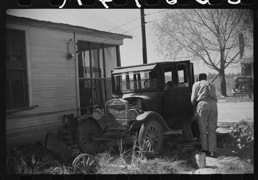 Untitled photo, possibly related to: Uncle George who has worked on Marcella Plantation in blacksmith and carpentry shop for last fifty years after he got out of prison, fixing his old car, Mileston, Mississippi Delta, Mississippi