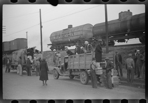 Untitled photo, possibly related to: Day laborers being hired for cotton picking on Mississippi and Arkansas plantations. Between four and six-thirty every morning during the season, near the Hallan Bridge in Memphis, Tennessee, crowds of Negroes in the streets gather and are loaded into trucks by d