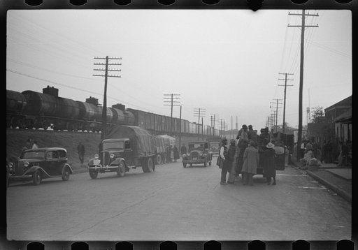 Untitled photo, possibly related to: Day laborers being hired for cotton picking on Mississippi and Arkansas plantations. Between four and six-thirty every morning during the season, near the Hallan Bridge in Memphis, Tennessee, crowds of Negroes in the streets gather and are loaded into trucks by d