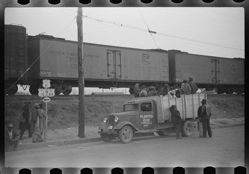 Untitled photo, possibly related to: Day laborers being hired for cotton picking on Mississippi and Arkansas plantations. Between four and six-thirty every morning during the season, near the Hallan Bridge in Memphis, Tennessee, crowds of Negroes in the streets gather and are loaded into trucks by d