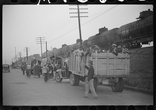 Untitled photo, possibly related to: Day laborers being hired for cotton picking on Mississippi and Arkansas plantations. Between four and six-thirty every morning during the season, near the Hallan Bridge in Memphis, Tennessee, crowds of Negroes in the streets gather and are loaded into trucks by d