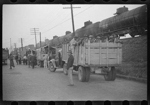 Untitled photo, possibly related to: Day laborers being hired for cotton picking on Mississippi and Arkansas plantations. Between four and six-thirty every morning during the season, near the Hallan Bridge in Memphis, Tennessee, crowds of Negroes in the streets gather and are loaded into trucks by d