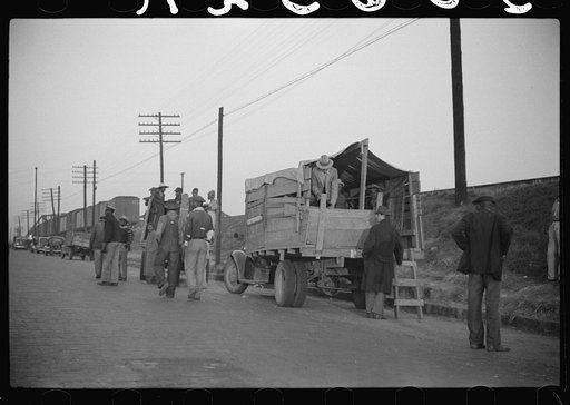 Untitled photo, possibly related to: Day laborers being hired for cotton picking on Mississippi and Arkansas plantations. Between four and six-thirty every morning during the season, near the Hallan Bridge in Memphis, Tennessee, crowds of Negroes in the streets gather and are loaded into trucks by d