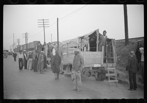 Untitled photo, possibly related to: Day laborers being hired for cotton picking on Mississippi and Arkansas plantations. Between four and six-thirty every morning during the season, near the Hallan Bridge in Memphis, Tennessee, crowds of Negroes in the streets gather and are loaded into trucks by d