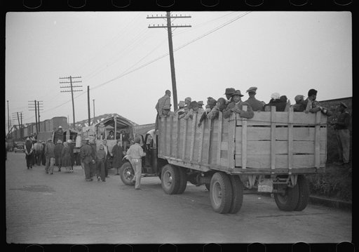 Untitled photo, possibly related to: Day laborers being hired for cotton picking on Mississippi and Arkansas plantations. Between four and six-thirty every morning during the season, near the Hallan Bridge in Memphis, Tennessee, crowds of Negroes in the streets gather and are loaded into trucks by d