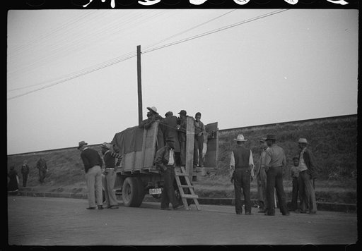Untitled photo, possibly related to: Day laborers being hired for cotton picking on Mississippi and Arkansas plantations. Between four and six-thirty every morning during the season, near the Hallan Bridge in Memphis, Tennessee, crowds of Negroes in the streets gather and are loaded into trucks by d