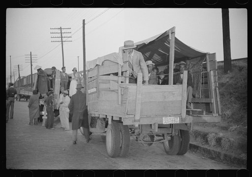 Untitled photo, possibly related to: Day laborers being hired for cotton picking on Mississippi and Arkansas plantations. Between four and six-thirty every morning during the season, near the Hallan Bridge in Memphis, Tennessee, crowds of Negroes in the streets gather and are loaded into trucks by d