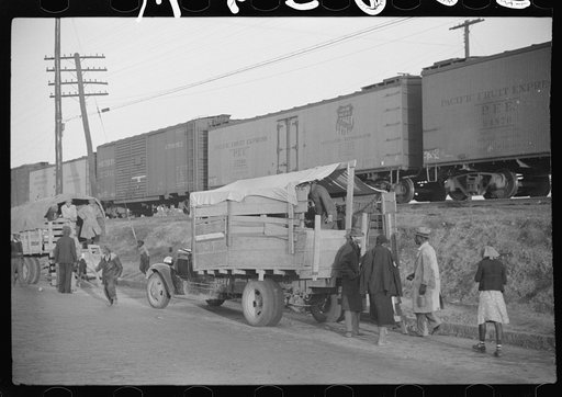 Untitled photo, possibly related to: Day laborers being hired for cotton picking on Mississippi and Arkansas plantations. Between four and six-thirty every morning during the season, near the Hallan Bridge in Memphis, Tennessee, crowds of Negroes in the streets gather and are loaded into trucks by d