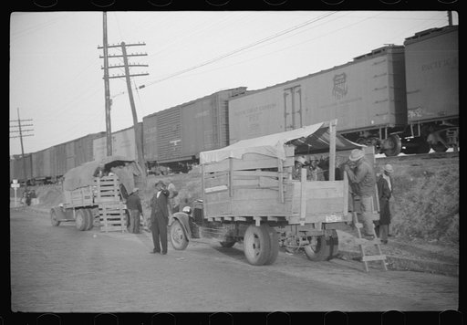 Untitled photo, possibly related to: Day laborers being hired for cotton picking on Mississippi and Arkansas plantations. Between four and six-thirty every morning during the season, near the Hallan Bridge in Memphis, Tennessee, crowds of Negroes in the streets gather and are loaded into trucks by d