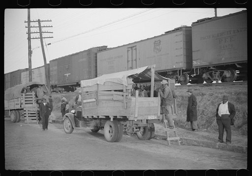 Untitled photo, possibly related to: Day laborers being hired for cotton picking on Mississippi and Arkansas plantations. Between four and six-thirty every morning during the season, near the Hallan Bridge in Memphis, Tennessee, crowds of Negroes in the streets gather and are loaded into trucks by d