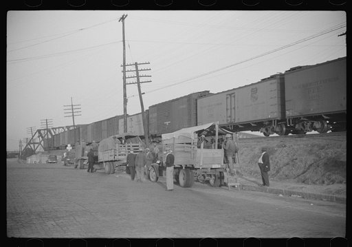 Untitled photo, possibly related to: Day laborers being hired for cotton picking on Mississippi and Arkansas plantations. Between four and six-thirty every morning during the season, near the Hallan Bridge in Memphis, Tennessee, crowds of Negroes in the streets gather and are loaded into trucks by d