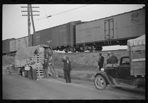 Untitled photo, possibly related to: Day laborers being hired for cotton picking on Mississippi and Arkansas plantations. Between four and six-thirty every morning during the season, near the Hallan Bridge in Memphis, Tennessee, crowds of Negroes in the streets gather and are loaded into trucks by d