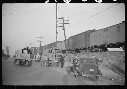 Untitled photo, possibly related to: Day laborers being hired for cotton picking on Mississippi and Arkansas plantations. Between four and six-thirty every morning during the season, near the Hallan Bridge in Memphis, Tennessee, crowds of Negroes in the streets gather and are loaded into trucks by d