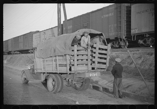 Untitled photo, possibly related to: Day laborers being hired for cotton picking on Mississippi and Arkansas plantations. Between four and six-thirty every morning during the season, near the Hallan Bridge in Memphis, Tennessee, crowds of Negroes in the streets gather and are loaded into trucks by d