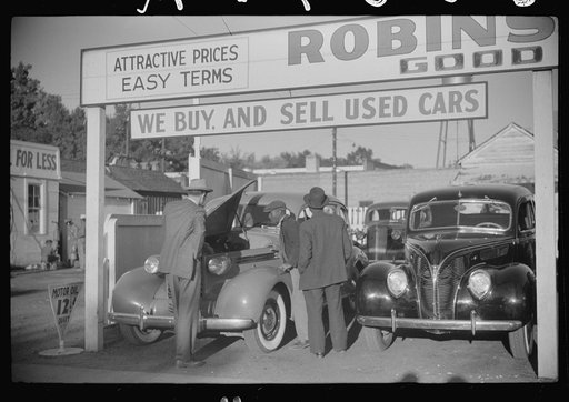 Used car lot, Clarksdale, Mississippi Delta, Mississippi. Big sales go on after cotton picking season to get the money cotton pickers have made. Many of the pickers buy new or used cars with their cotton money
