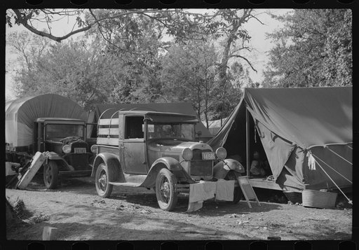 Untitled photo, possibly related to: Fixing truck in front of tents of Mexican labor brought from Texas by contractor for the duration of cotton picking season. Hopson Plantation, near Clarksdale, Mississippi Delta, Mississippi