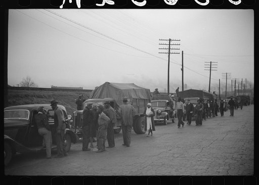 Untitled photo, possibly related to: Day laborers being hired for cotton picking on Mississippi and Arkansas plantations. Between four and six-thirty every morning during the season, near the Hallan Bridge in Memphis, Tennessee, crowds of Negroes in the streets gather and are loaded into trucks by d