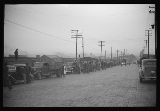 Untitled photo, possibly related to: Day laborers being hired for cotton picking on Mississippi and Arkansas plantations. Between four and six-thirty every morning during the season, near the Hallan Bridge in Memphis, Tennessee, crowds of Negroes in the streets gather and are loaded into trucks by d