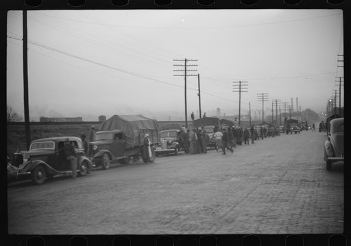 Untitled photo, possibly related to: Day laborers being hired for cotton picking on Mississippi and Arkansas plantations. Between four and six-thirty every morning during the season, near the Hallan Bridge in Memphis, Tennessee, crowds of Negroes in the streets gather and are loaded into trucks by d