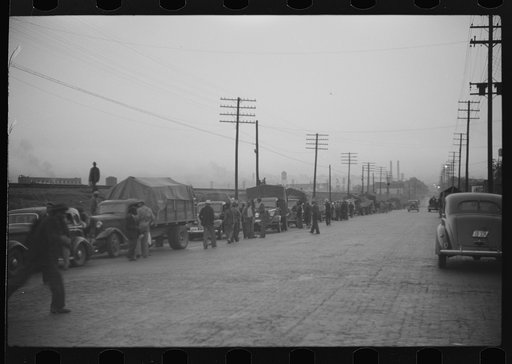 Untitled photo, possibly related to: Day laborers being hired for cotton picking on Mississippi and Arkansas plantations. Between four and six-thirty every morning during the season, near the Hallan Bridge in Memphis, Tennessee, crowds of Negroes in the streets gather and are loaded into trucks by d
