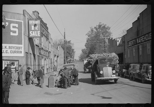 Truckload of tobacco after being sold at warehouse is hauled to the cigarette storage warehouse, Durham, North Carolina