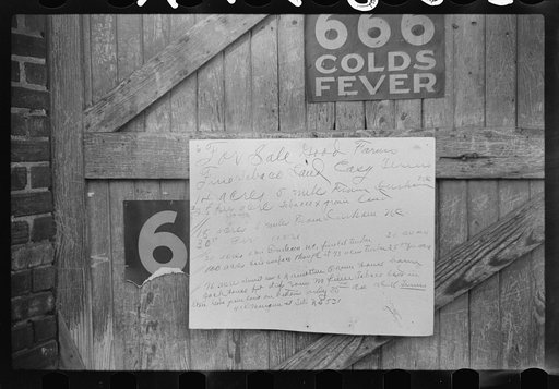 Sign on outside of tobacco warehouse during auction sales, Durham, North Carolina