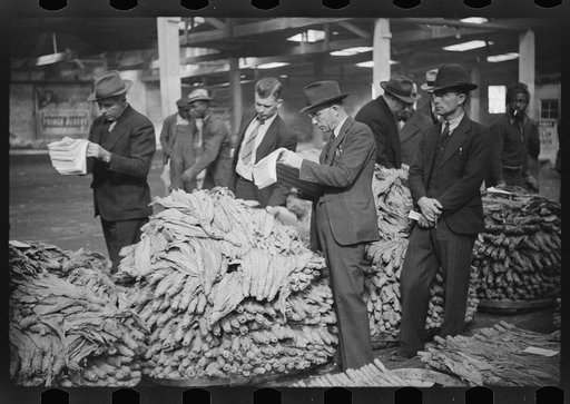 Untitled photo, possibly related to: Bookmen following the sale and checking the price of the tobacco for the warehouse, Durham, North Carolina