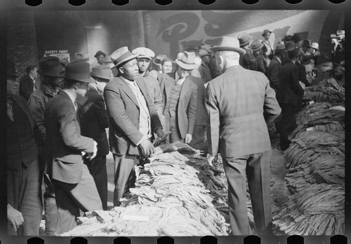 Negro farmer talking with warehouse man about price he received at auction for his tobacco, Durham, North Carolina