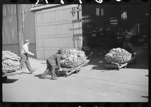Untitled photo, possibly related to: Taking tobacco into warehouse for auction, Durham, North Carolina