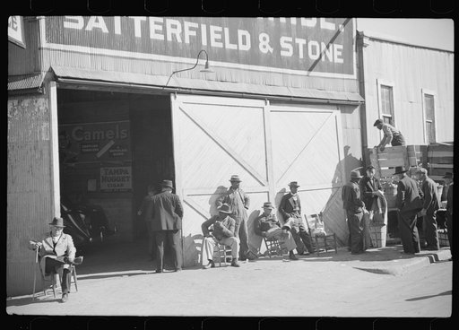Farmers waiting and buying apples outside warehouse during tobacco auctions. Durham, North Carolina