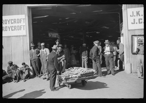 Outside tobacco warehouse after auction sale. Durham, North Carolina