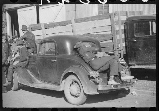 Untitled photo, possibly related to: Very often farmers must travel long distances at night or wait several days for tobacco to be sold. They can be found sleeping on the covered piles of tobacco in warehouses or in their trucks or the floors of camp rooms. Durham, North Carolina