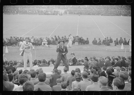 Untitled photo, possibly related to: Kay Kyser and cheerleader cheering for North Carolina team at Duke University-North Carolina football game. Durham, North Carolina