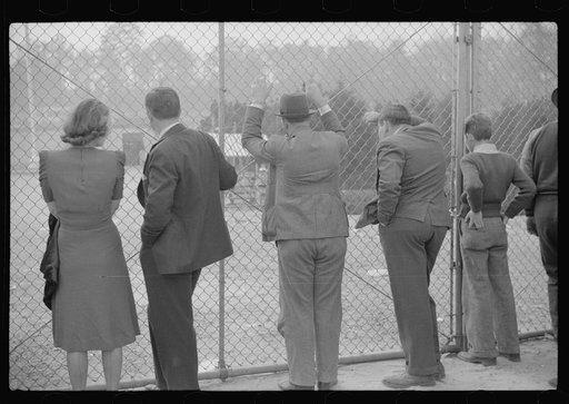 Spectators standing outside the gate of the Duke University Stadium because there were no more seating accomodations. Duke University-North Carolina game. Durham, North Carolina