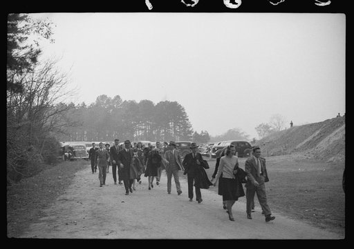 Untitled photo, possibly related to: Spectators standing outside the gate of the Duke University Stadium because there were no more seating accomodations. Duke University-North Carolina game. Durham, North Carolina