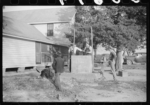 Men drinking from well on farm near the Fred Wilkins place. They have been shucking corn. Granville County, North Carolina