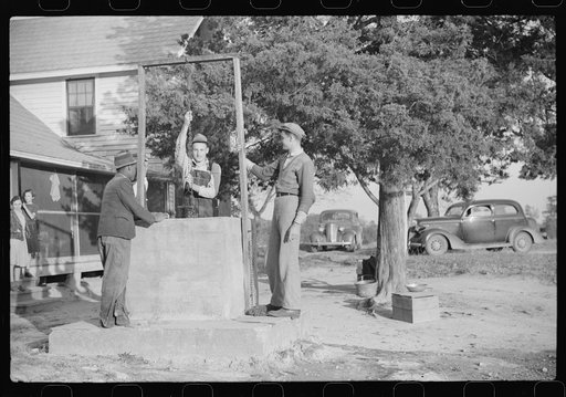 Untitled photo, possibly related to: Men drinking from well on farm near the Fred Wilkins place. They have been shucking corn. Granville County, North Carolina