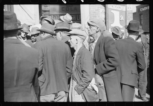 Spectators listening to patent medicine salesman who has his stand outside tobacco warehouse during tobacco auction sales. Durham, North Carolina