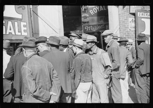 Untitled photo, possibly related to: Spectators listening to patent medicine salesman who has his stand outside tobacco warehouse during tobacco auction sales. Durham, North Carolina