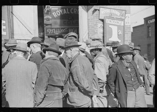 Spectators listening to patent medicine salesman who has his stand outside tobacco warehouse during tobacco auction sales. Durham, North Carolina