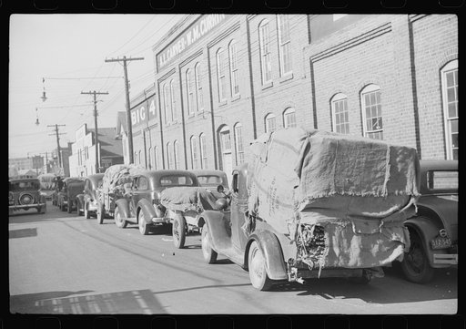 Farmers bringing tobacco to warehouse in trailers, on top of their cars and even inside their cars for auction. Durham, North Carolina