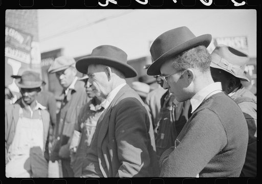 Untitled photo, possibly related to: Patent medicine salesman demonstrating his wares to farmers outside warehouse during tobacco auction sale. Durham, North Carolina