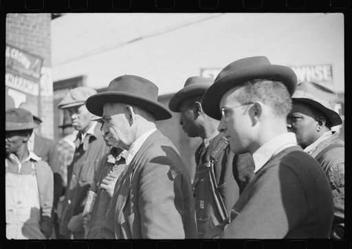 Untitled photo, possibly related to: Patent medicine salesman demonstrating his wares to farmers outside warehouse during tobacco auction sale. Durham, North Carolina
