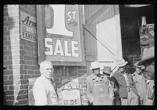 Untitled photo, possibly related to: Farmer buying patent medicine from salesman outside tobacco warehouse during auction sale. Durham, North Carolina